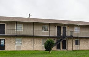 Killeen apartment for rent - A building with a balcony and a tree in front of it.
