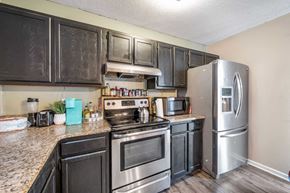 Hubert house for rent - a kitchen with stainless steel appliances and granite counter tops