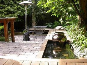 Vancouver apartment for rent - A small garden with a table and chairs.