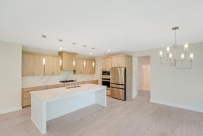 Blaine house for rent - a kitchen with wooden cabinets and a white counter top