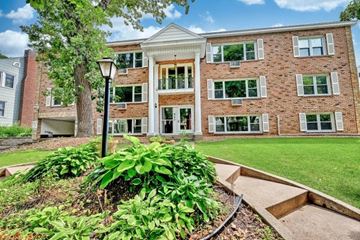 Minneapolis apartment for rent - a large brick building with a garden in front of it