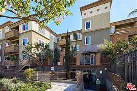 Los Angeles apartment for rent - an apartment building with a sidewalk and a gate