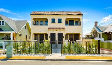 Los Angeles apartment for rent - A yellow house with a black gate in front.