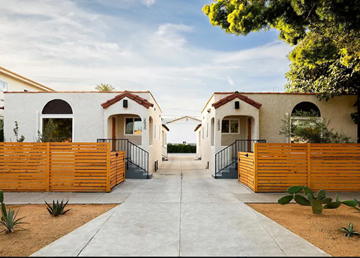Los Angeles apartment for rent - A row of houses with wooden fences and cacti in front.
