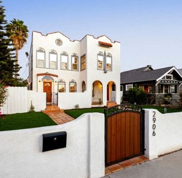 Los Angeles apartment for rent - A white house with a black mailbox and a wooden gate.