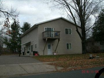 Menomonie apartment for rent - a house with a balcony on the side of a street