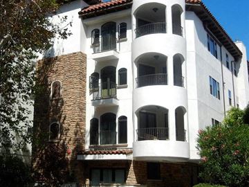 Los Angeles apartment for rent - a white building with balconies and a tree
