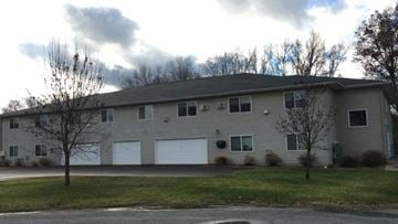Menomonie apartment for rent - A grey building with a white garage door.