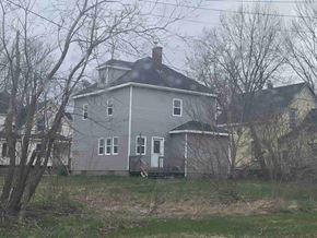New Glasgow apartment for rent - a gray house with a black roof and some trees