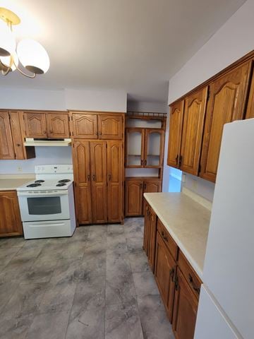 New Glasgow apartment for rent - a kitchen with wooden cabinets and a white stove and refrigerator