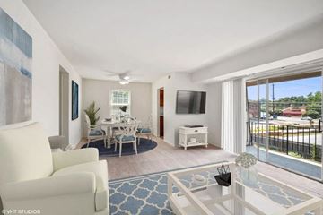 Gaithersburg apartment for rent - a living room with a couch and a table and a television