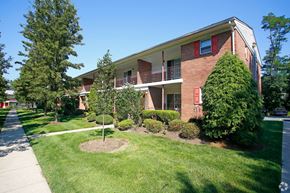Neptune apartment for rent - an apartment building with a lawn and trees