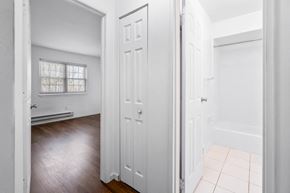 Eatontown apartment for rent - an empty bedroom with white closets and a wood floor
