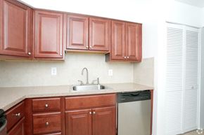 Eatontown apartment for rent - a kitchen with wooden cabinets and a sink and a dishwasher