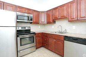 Eatontown apartment for rent - a kitchen with wooden cabinets and stainless steel appliances