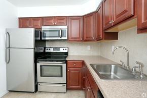 Eatontown apartment for rent - a kitchen with cherry cabinets and stainless steel appliances