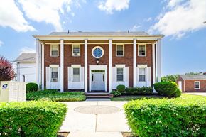Clifton apartment for rent - the front of a brick building with a clock on it