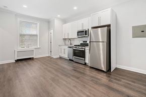 Summit apartment for rent - A kitchen with a refrigerator, oven, and microwave.