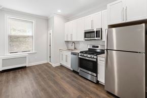 Summit apartment for rent - A kitchen with a refrigerator, oven, and microwave.
