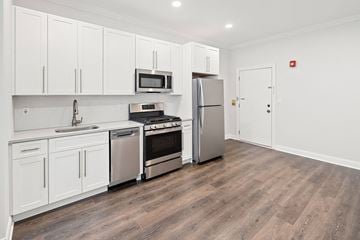 Summit apartment for rent - A kitchen with white cabinets and stainless steel appliances.
