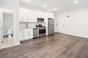 Summit apartment for rent - A kitchen with white cabinets and a wood floor.