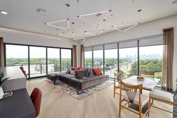 Nashville apartment for rent - A modern living room with a grey sofa and a wooden table.