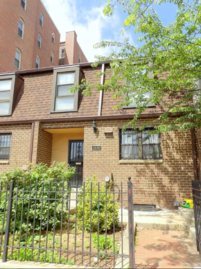 Washington apartment for rent - a brick house with a metal fence in front of it