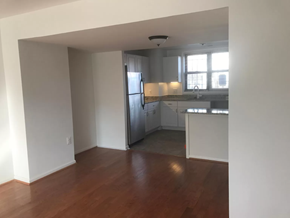 Washington apartment for rent - an empty living room and kitchen with a wooden floor
