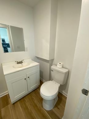 Louisville apartment for rent - A white toilet sits next to a sink in a small bathroom.