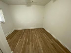 Louisville apartment for rent - A room with wooden flooring and white walls.