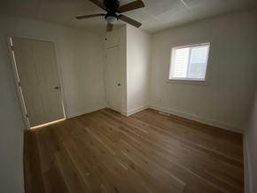 Louisville apartment for rent - A room with a ceiling fan and wooden flooring.