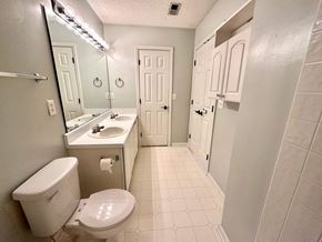 Greer house for rent - A white toilet with a sink and mirror in a bathroom.