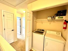 Greer house for rent - A small laundry room with a washer and dryer.