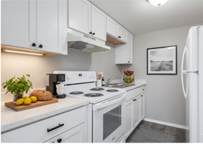 Cincinnati apartment for rent - A white kitchen with a refrigerator on the right.