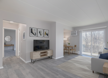 Cincinnati apartment for rent - A living room with a grey couch and a television.