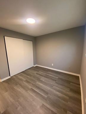 Cincinnati apartment for rent - A room with a wooden floor and a white door.