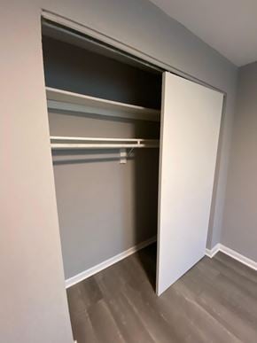 Cincinnati apartment for rent - A white closet with shelves and a door open.