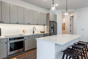 Dallas apartment for rent - a kitchen with a white counter top and stainless steel appliances