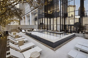 Dallas apartment for rent - an outdoor lounge area with a pool and a building in the background