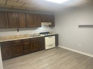 Chester apartment for rent - A kitchen with a white dishwasher and wooden cabinets.