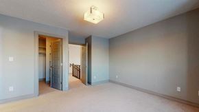 Edmonton house for rent - an empty living room with a blue wall and a staircase