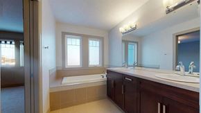 Edmonton house for rent - a bathroom with two sinks and a bath tub