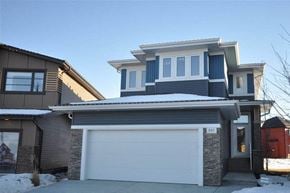 Edmonton house for rent - a house with a white garage door in front of it