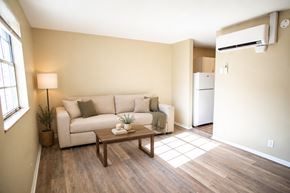 Knoxville apartment for rent - A living room with a couch, a coffee table, and a window.
