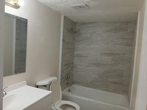 Knoxville apartment for rent - A bathroom with a white toilet and a white sink.