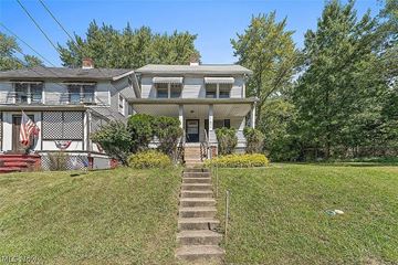 Maple Heights house for rent - a blue house with stairs in front of it