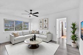 Miami apartment for rent - A living room with a white couch, a coffee table, and a ceiling fan.