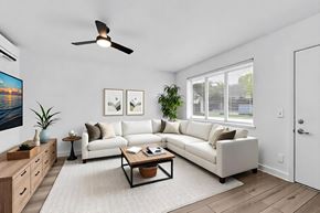 Miami apartment for rent - A living room with a white couch, a coffee table, and a ceiling fan.