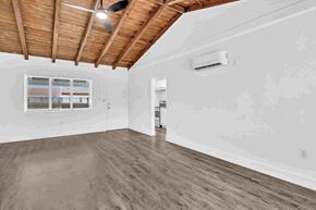 Miami apartment for rent - A room with wooden floors and a ceiling fan.