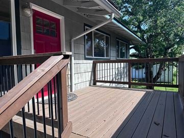 Coeur D Alene apartment for rent - a deck with a house with a red door